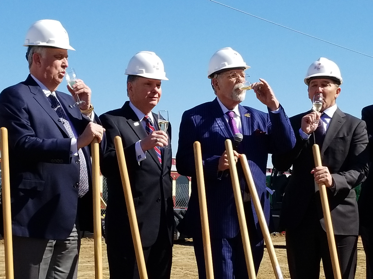 From left, Scott Mahaffey, chairman of the board for Trinity Metro; Paul Ballard, president and CEO of Trinity Metro; Grapevine Mayor William D. Tate; and Paul Coury, CEO of Coury Hospitality, share a toast Wednesday, March 7, at the groundbreaking for Grapevine Main. Nicholas Sakelaris Special to the Star-Telegram